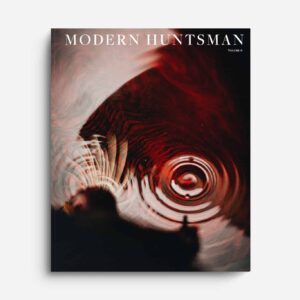 A cover of Modern Huntsman magazine featuring a close-up of water ripples with a red hue, emphasizing themes of hunting, conservation, and outdoor exploration.