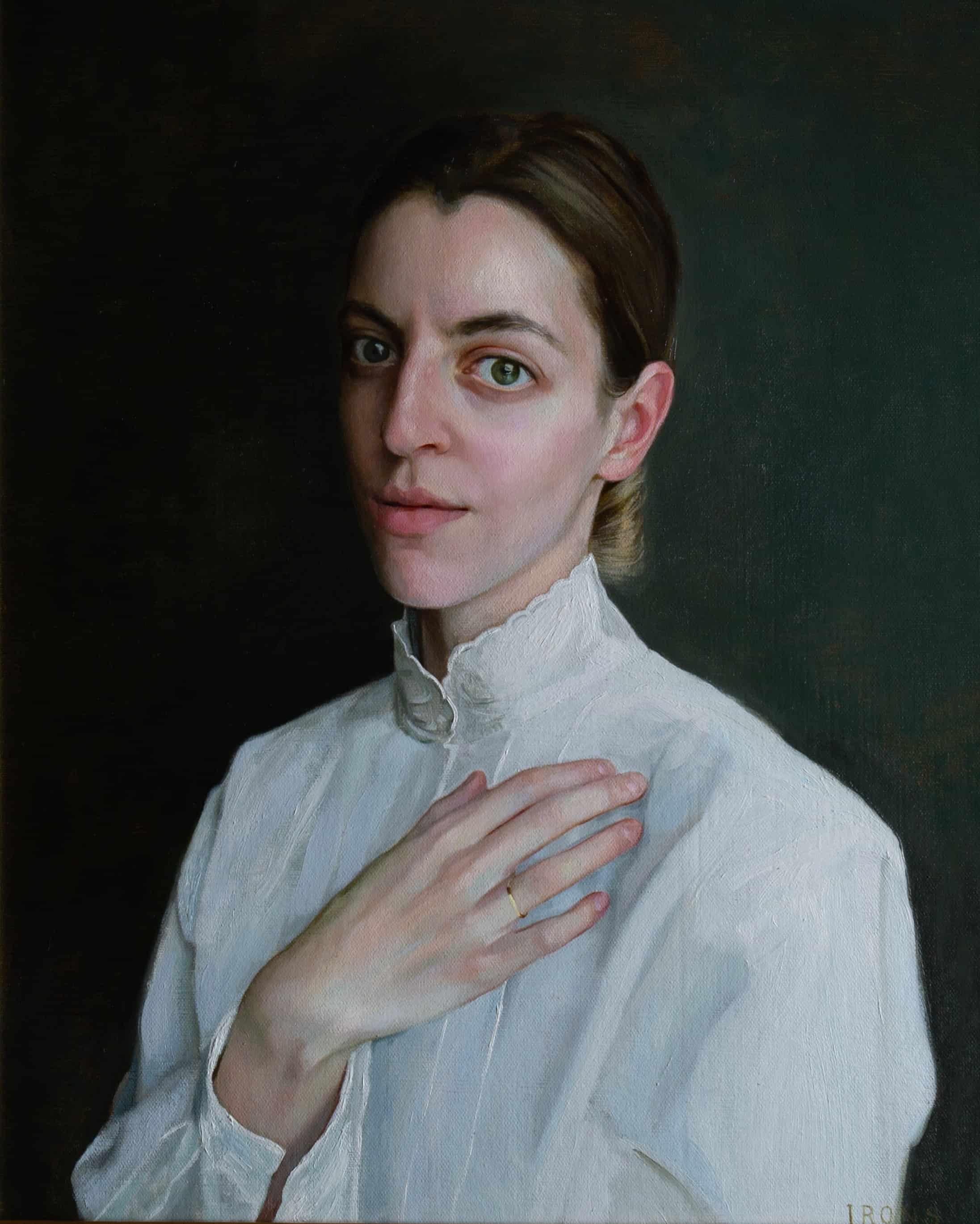 Self portrait of Morgan Irons with a white blouse and her hand on her chest