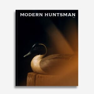 Handcrafted wooden duck decoy artwork from Modern Huntsman magazine, emphasizing fine craftsmanship and hunting heritage with a sleek, artistic presentation.