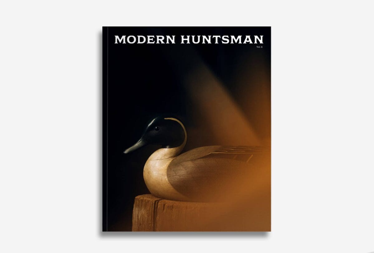 Handcrafted wooden duck decoy artwork from Modern Huntsman magazine, emphasizing fine craftsmanship and hunting heritage with a sleek, artistic presentation.