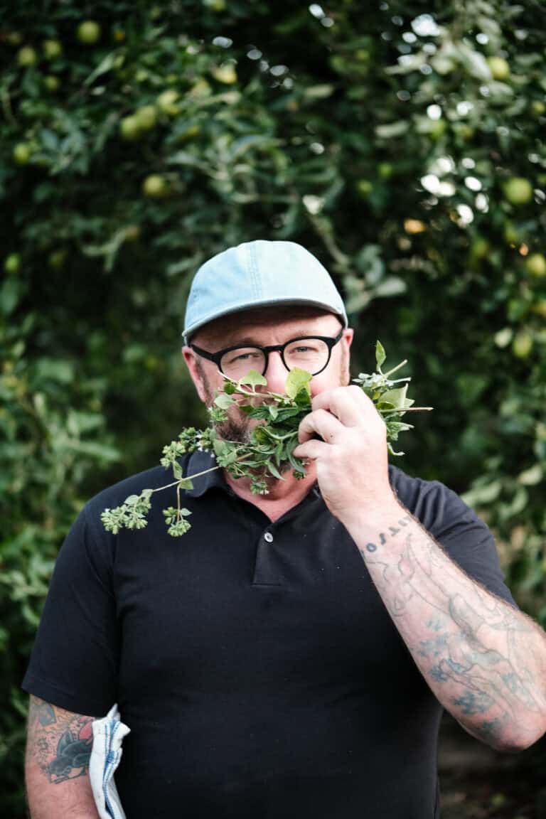 Elias Cairo smelling herbs in preparation for cooking